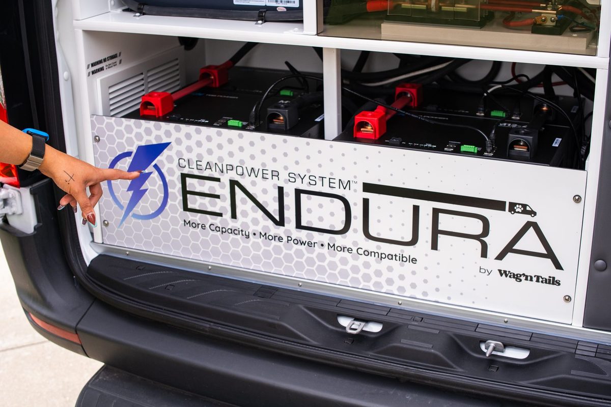 Close-up of CleanPower System Endura batteries and branding panel in a Wag'n Tails van