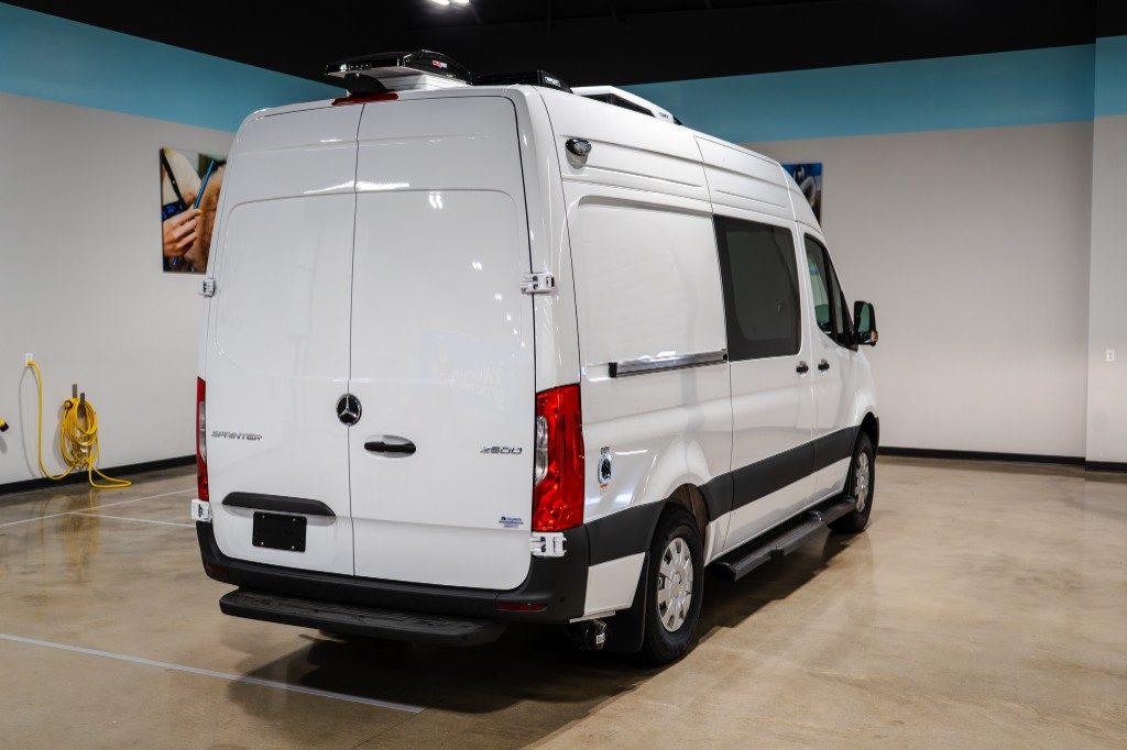 White Quantum Groom Mercedes-Benz Sprinter 2500, rear three-quarter showroom view with low-profile rooftop A/C