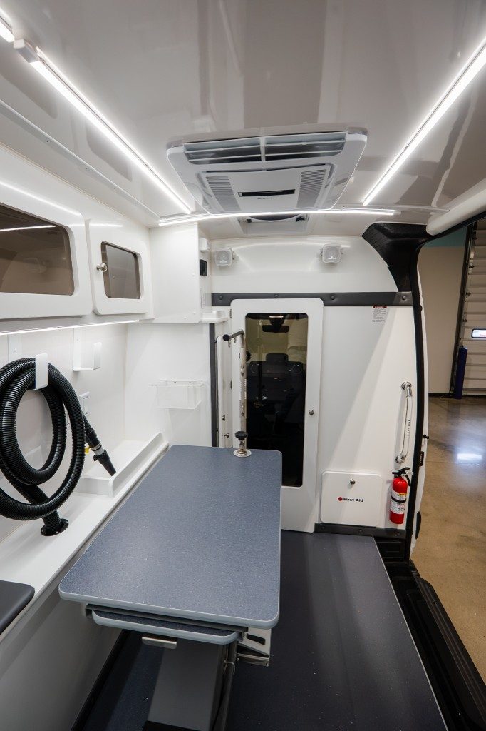 Quantum salon looking forward toward the cab partition with Smart Table and coiled dryer hose