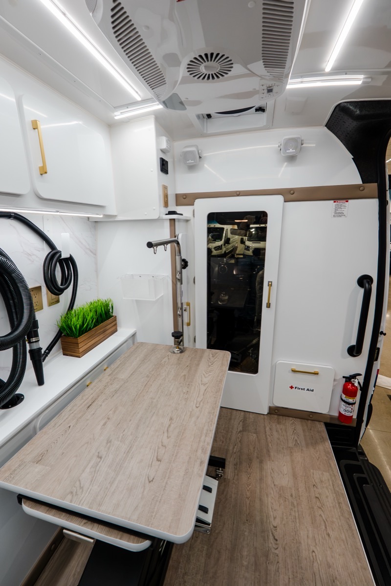 Quantum Luxe salon workspace with Smart Table, dryer hoses, and premium finishes