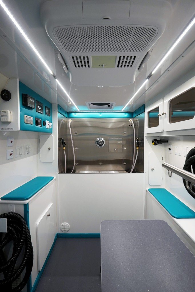 Ultra Groom salon interior looking toward the bathing tub with teal accents
